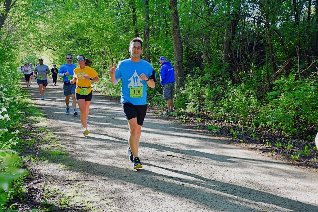 Greg Macek running on a trail in a half marathon